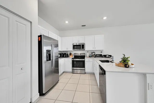 a view of a livingroom with furniture and a potted plant