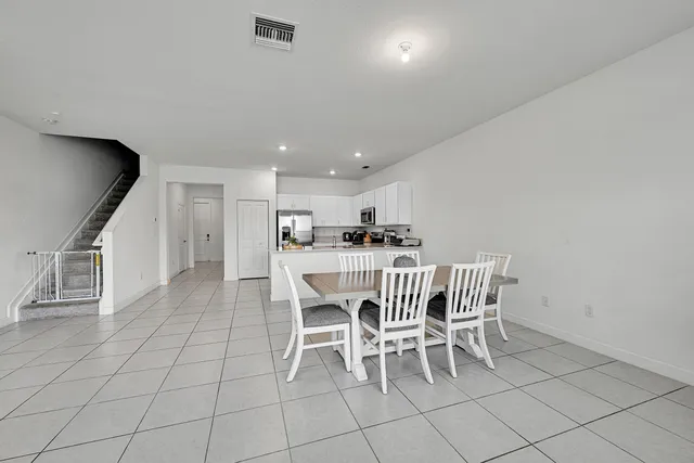 a bedroom with a bed and a potted plant