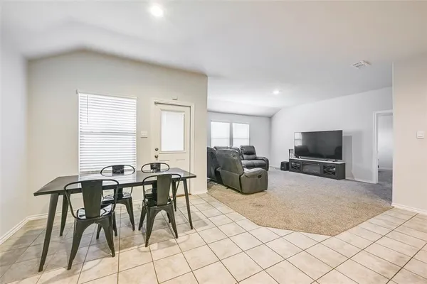 a view of a room that has a table and chair in it