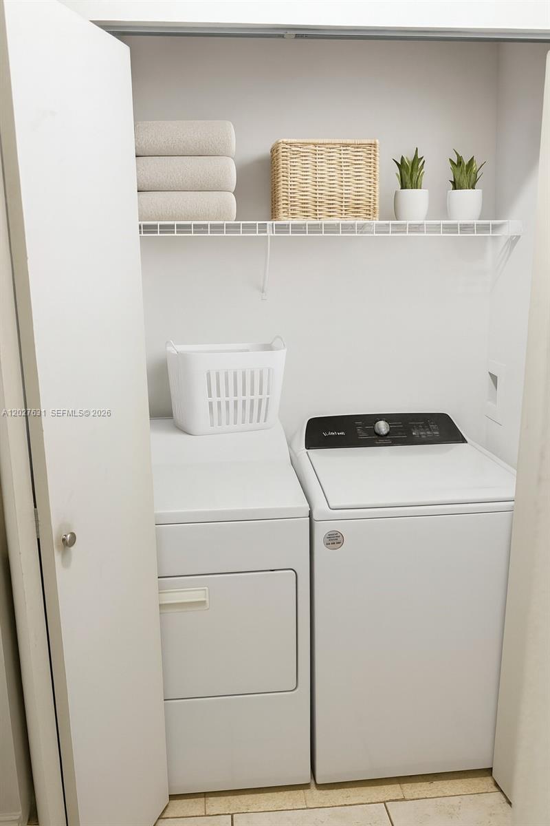 2081 Renaissance Boulevard, Unit 306 Miramar, FL 33025 - Photo 12 of 22 a utility room with dryer and washer