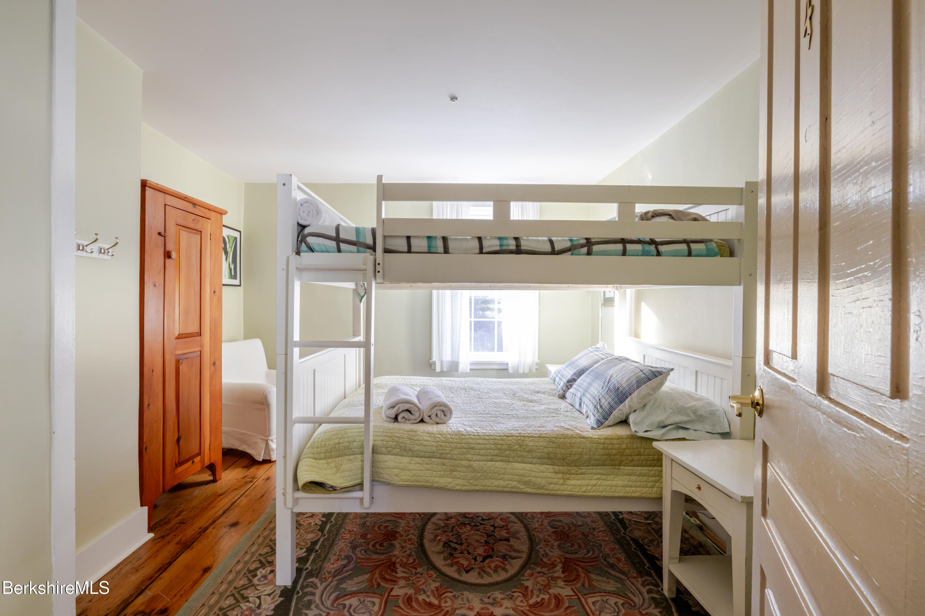 3 Lake Buel Road Great Barrington, MA 01230 - Photo 32 of 55 a bedroom with a bed and wooden floor
