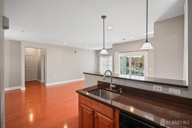 a kitchen with a sink a counter top space and cabinets