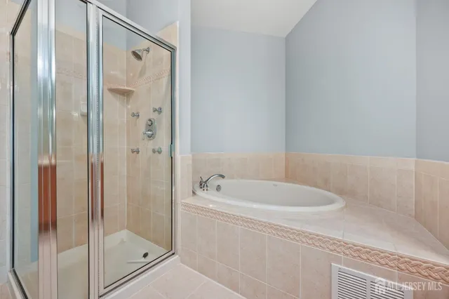 a bathroom with a bathtub and a shower
