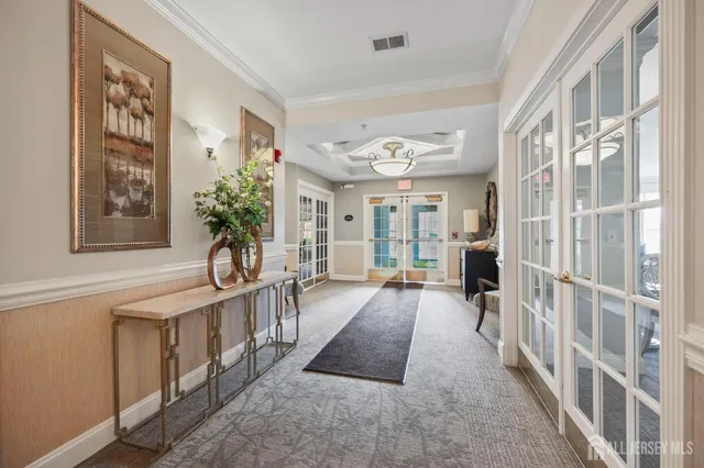 a view of an entryway with wooden floor and a livingroom