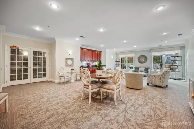 a living room with furniture a window and kitchen view