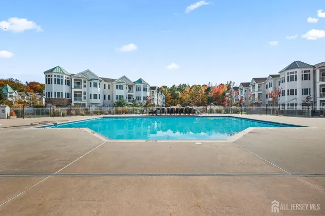 a view of swimming pool and a yard in front of the house