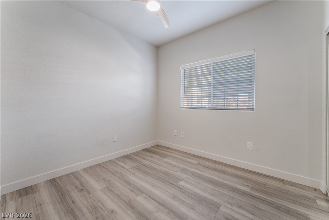 4730 East Craig Road, Unit 1058 Las Vegas, NV 89115 - Photo 21 of 30 A well-lit room features resilient wood flooring and a modern ceiling fan for comfort.