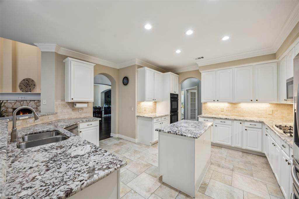 4528 Risinghill Drive Plano, TX 75024 - Photo 12 of 40 a kitchen with stainless steel appliances granite countertop a sink stove and refrigerator