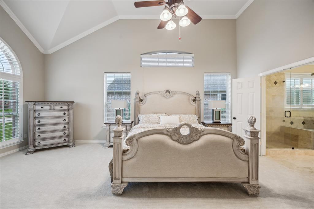 4528 Risinghill Drive Plano, TX 75024 - Photo 19 of 40 a bedroom with a bed and a chandelier