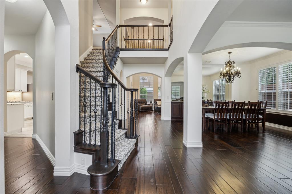 4528 Risinghill Drive Plano, TX 75024 - Photo 2 of 40 a view of a hallway with wooden floor table and a dining table chairs