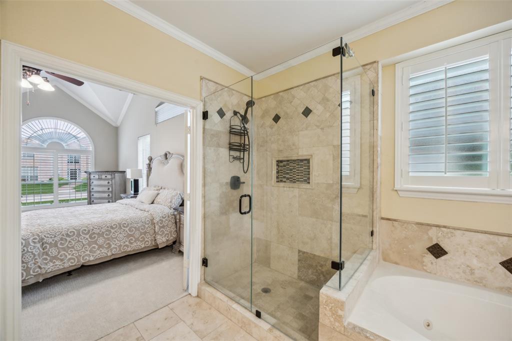 4528 Risinghill Drive Plano, TX 75024 - Photo 24 of 40 a bathroom with a tub shower and sink