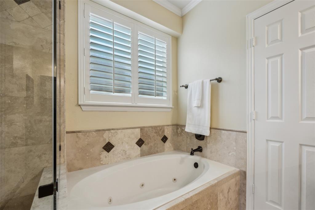 4528 Risinghill Drive Plano, TX 75024 - Photo 25 of 40 a bathroom with a bathtub and a shower