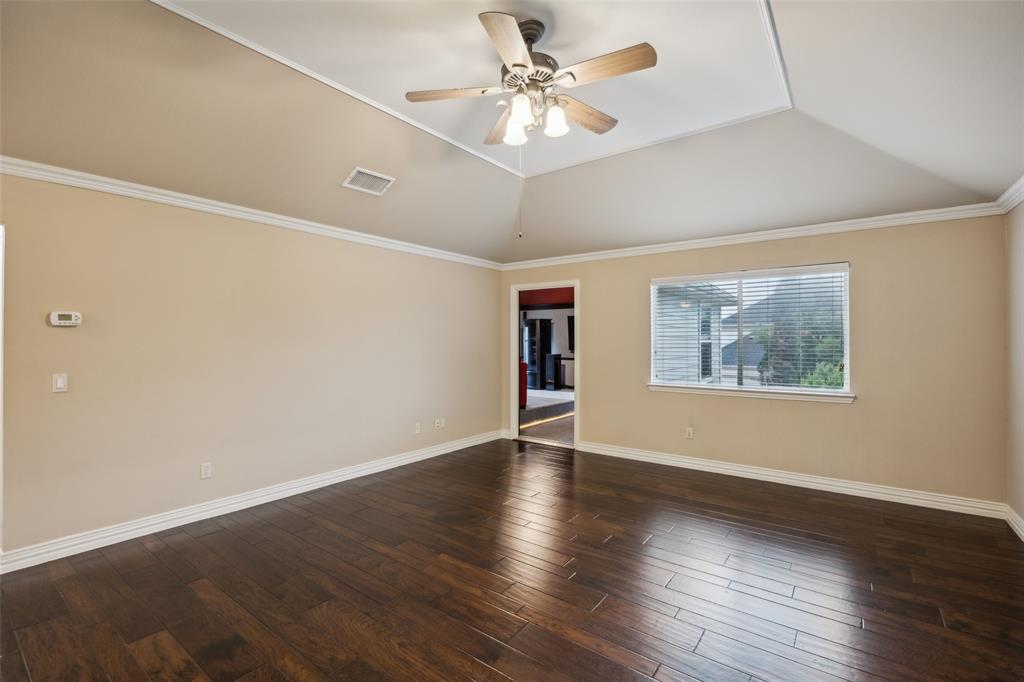 4528 Risinghill Drive Plano, TX 75024 - Photo 28 of 40 an empty room with wooden floor chandelier fan and windows