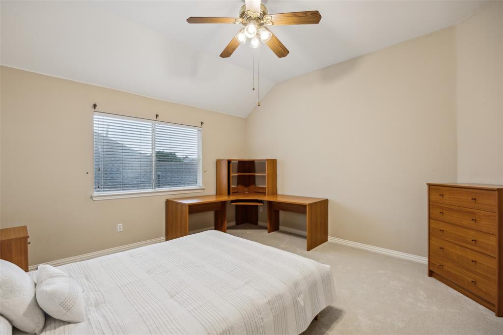 4528 Risinghill Drive Plano, TX 75024 - Photo 31 of 40 a bedroom with a bed and a chandelier