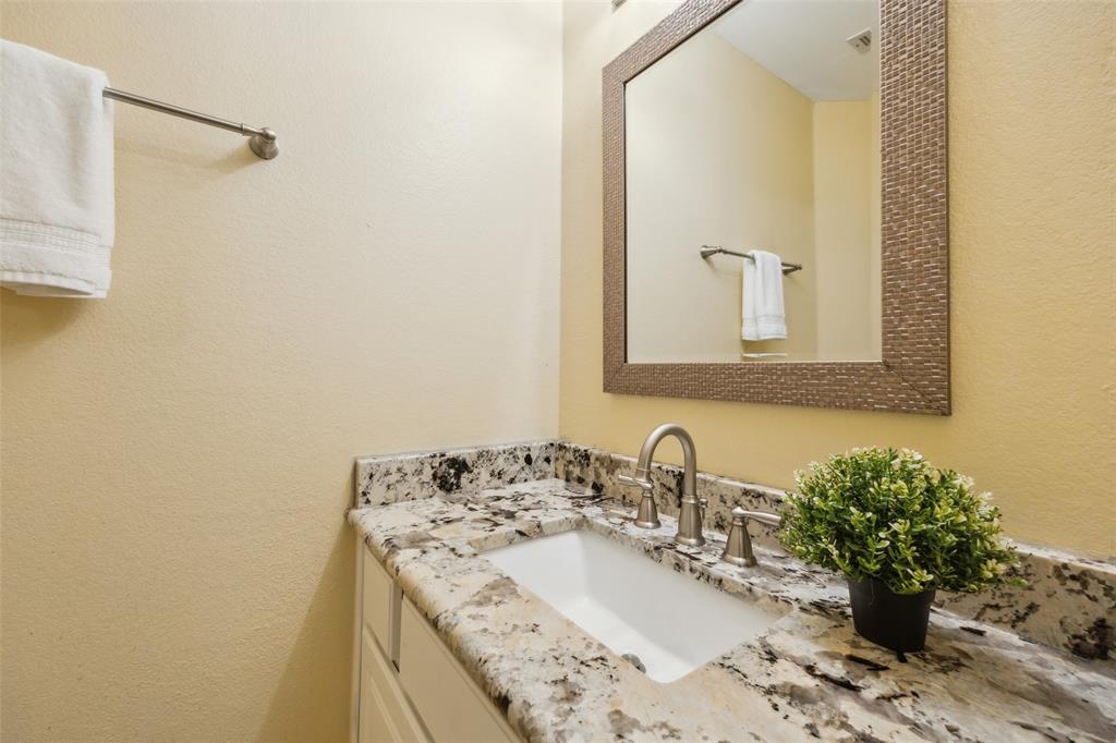 4528 Risinghill Drive Plano, TX 75024 - Photo 33 of 40 a bathroom with a granite countertop sink and a mirror