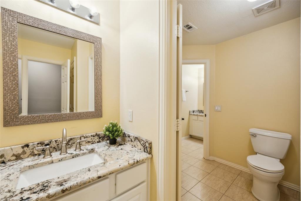 4528 Risinghill Drive Plano, TX 75024 - Photo 34 of 40 a bathroom with a granite countertop sink toilet and shower