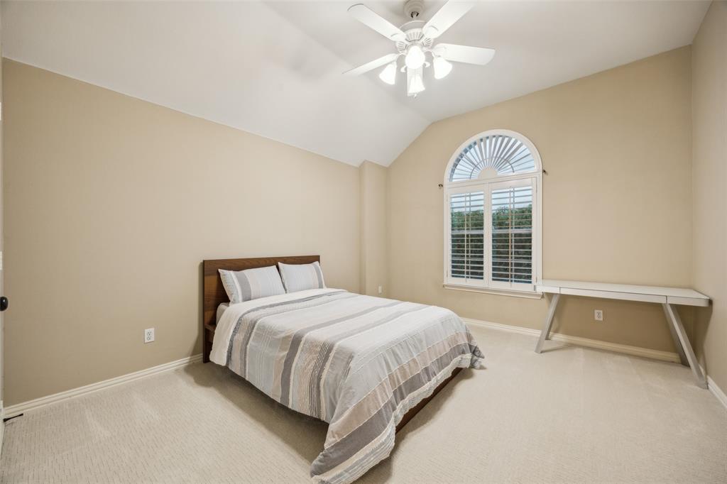 4528 Risinghill Drive Plano, TX 75024 - Photo 35 of 40 a bedroom with a large bed and a chandelier