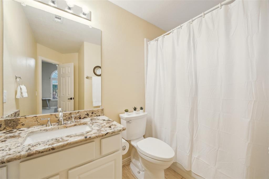 4528 Risinghill Drive Plano, TX 75024 - Photo 36 of 40 a bathroom with a granite countertop sink and a mirror