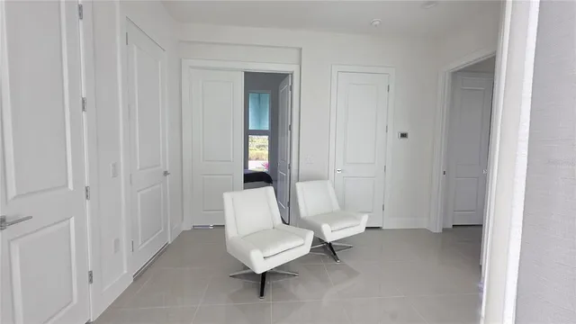 a bedroom with a bed and a lamp on dresser