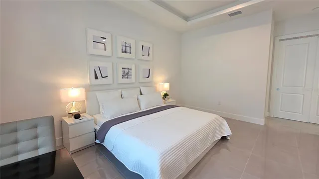 a view of an empty room with closet and a mirror