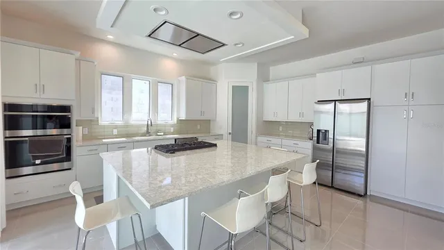 a kitchen with a center island and stainless steel appliances