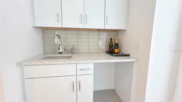 a kitchen with a sink and cabinets