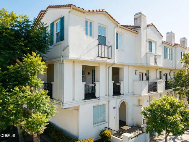 a front view of a house with white walls