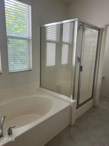 a bathroom with a bathtub and a shower
