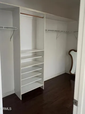 a view of walk in closet with empty racks