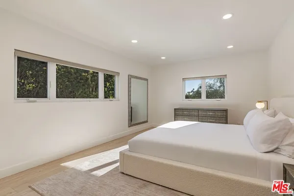 a bedroom with a large bed and a window