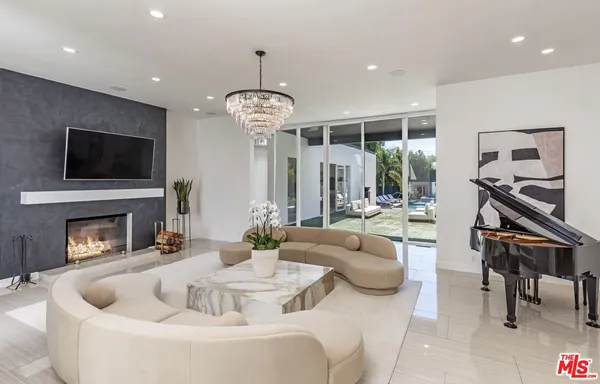 a living room with furniture a fireplace and a flat screen tv