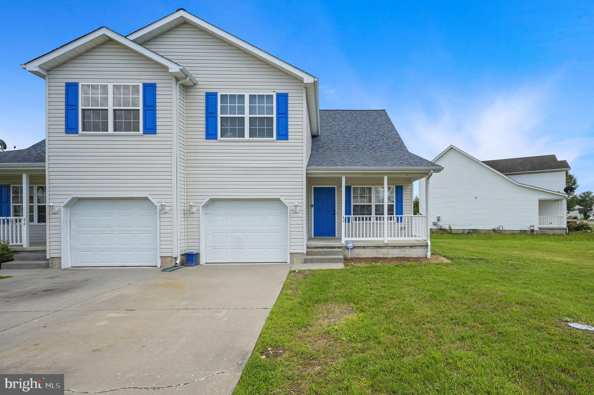 a front view of a house with a garden and yard