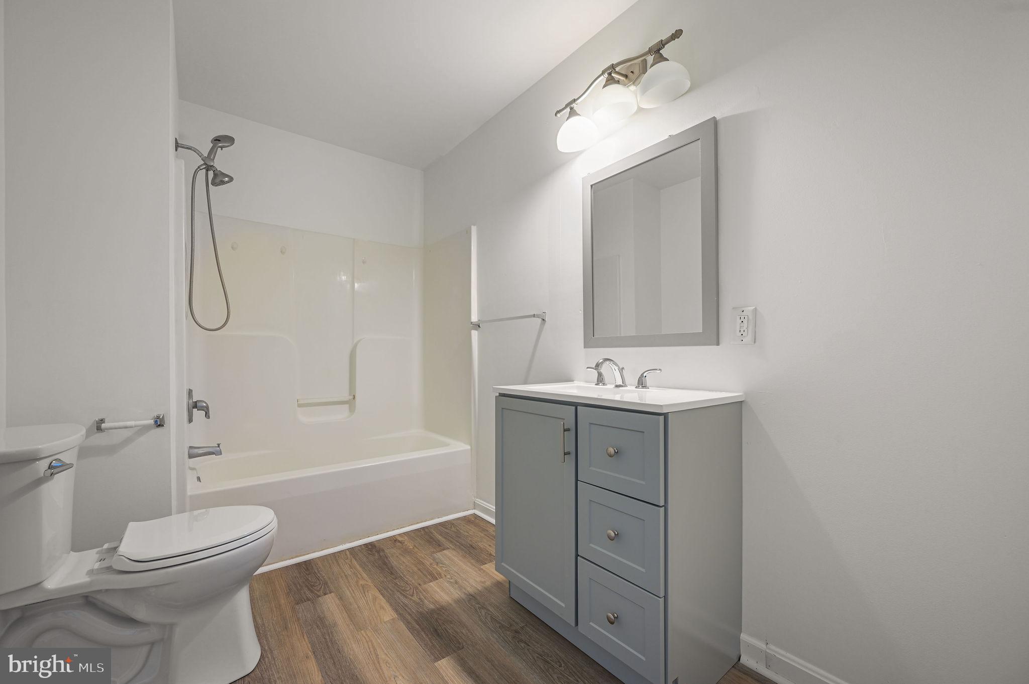 44 Moriarty Street Dover, DE 19901 - Photo 13 of 15 a bathroom with a sink a toilet and shower