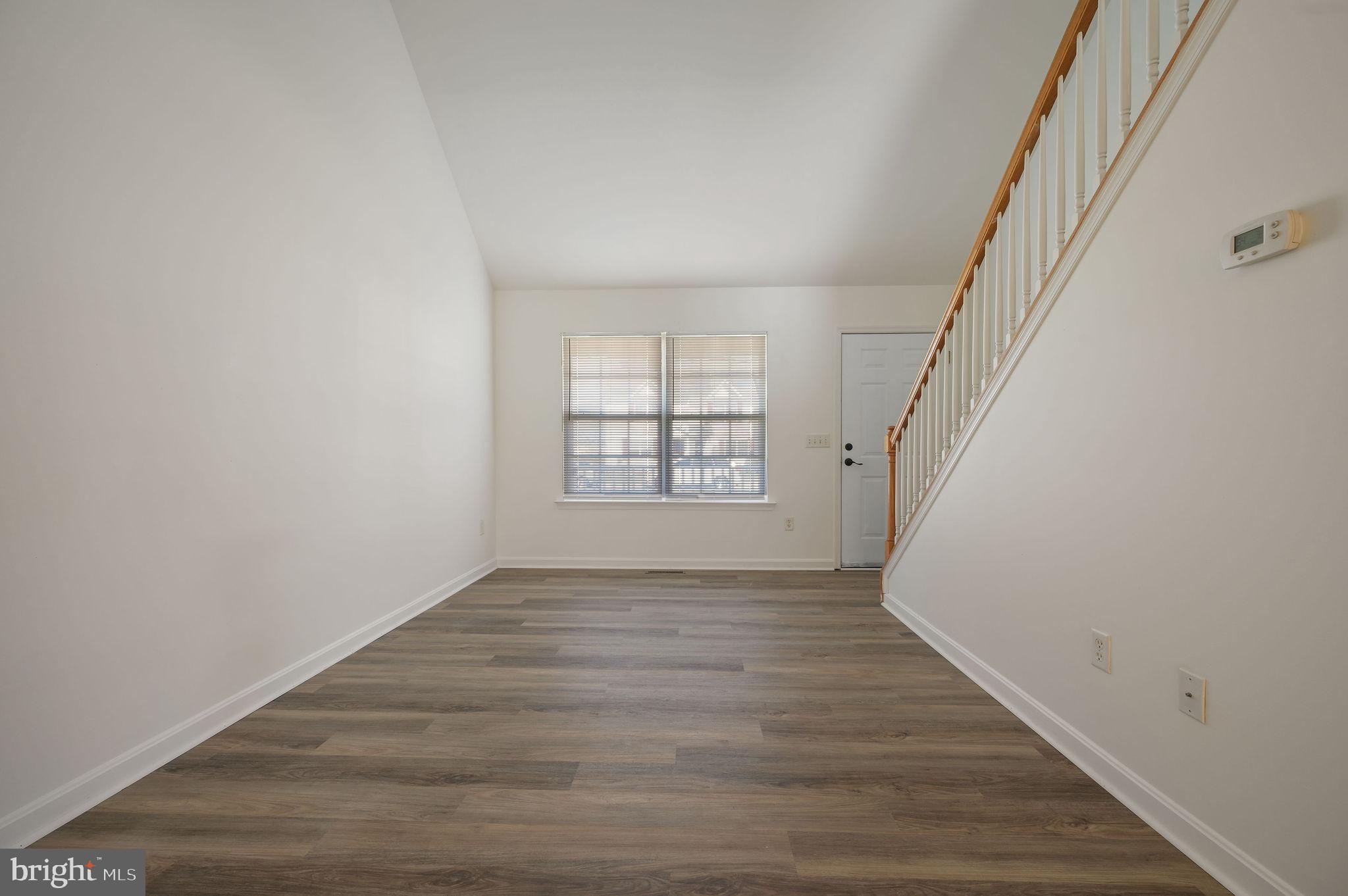 44 Moriarty Street Dover, DE 19901 - Photo 2 of 15 wooden floor in an empty room with a window