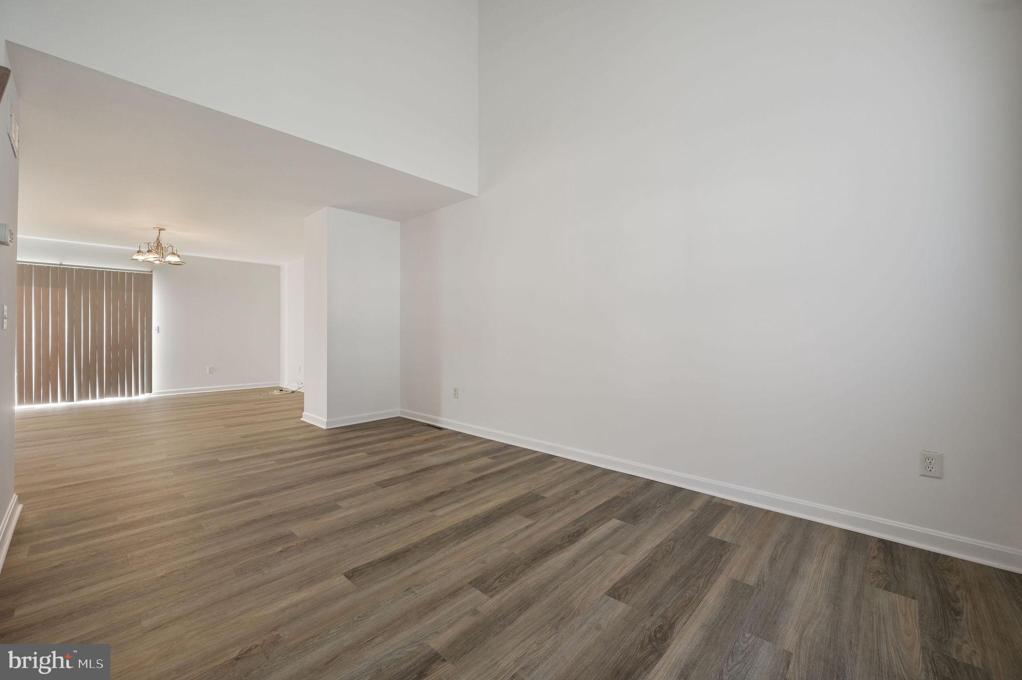 44 Moriarty Street Dover, DE 19901 - Photo 3 of 15 a view of an empty room with wooden floor and a window