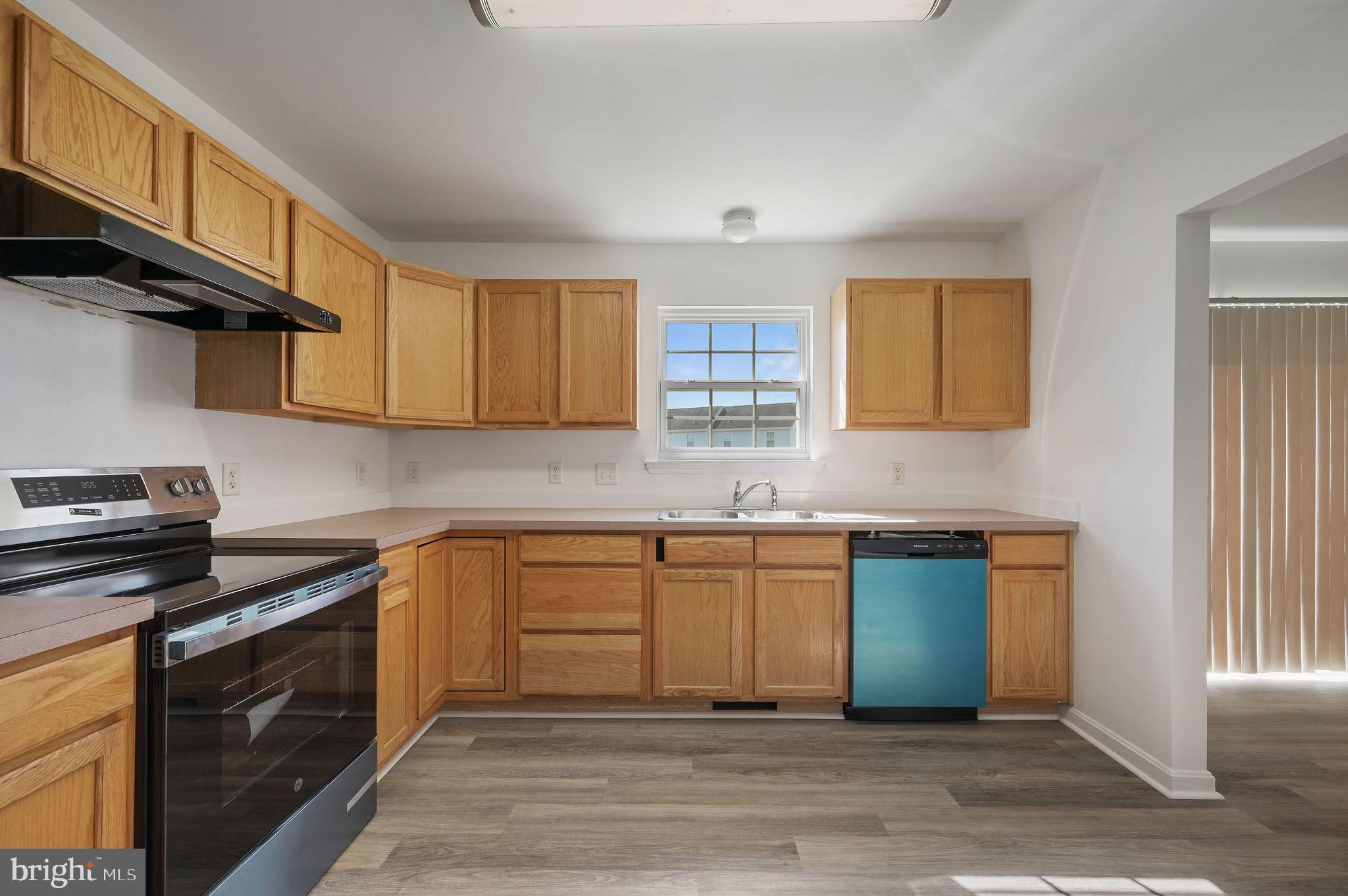44 Moriarty Street Dover, DE 19901 - Photo 7 of 15 a kitchen with stainless steel appliances granite countertop a sink stove and cabinets