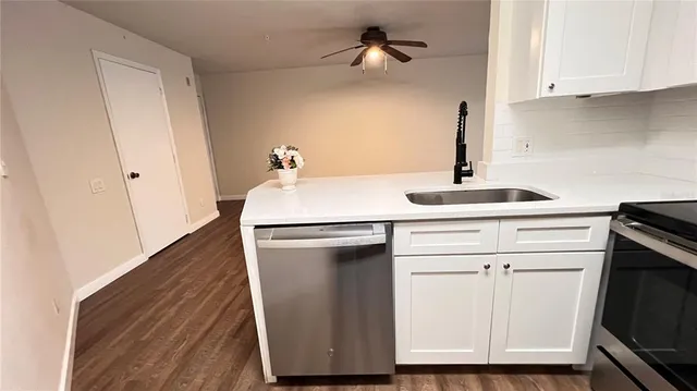 a kitchen with a sink appliances and cabinets