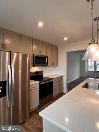 a kitchen with stainless steel appliances a refrigerator sink and stove