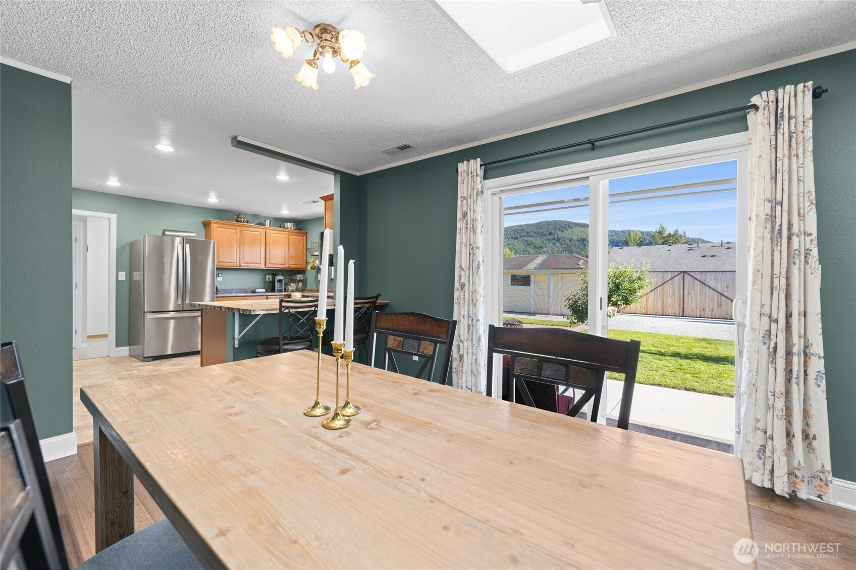 415 Sterling Street Sedro-Woolley, WA 98284 - Photo 14 of 38 a kitchen with kitchen island a large window in it
