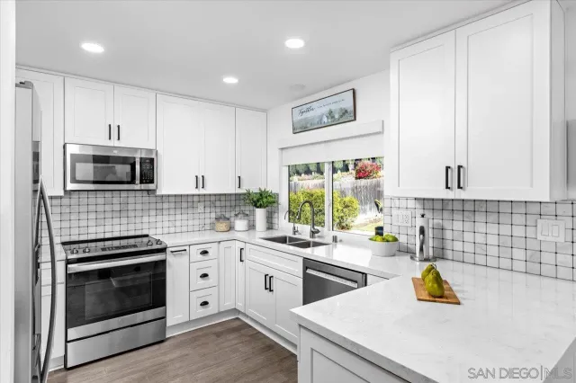 a kitchen with a sink stove and cabinets