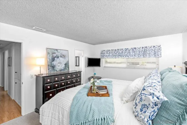 a bedroom with a bed and a dresser