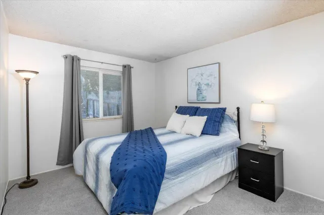 a bed room with a bed and a night stand