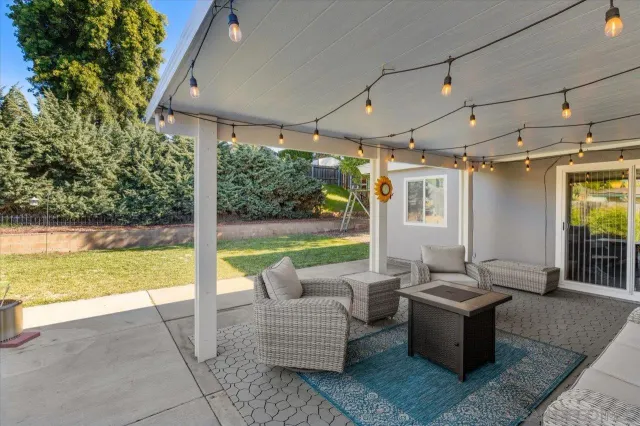 a living room with patio furniture and garden