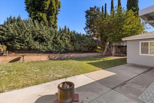 a view of a backyard with swimming pool