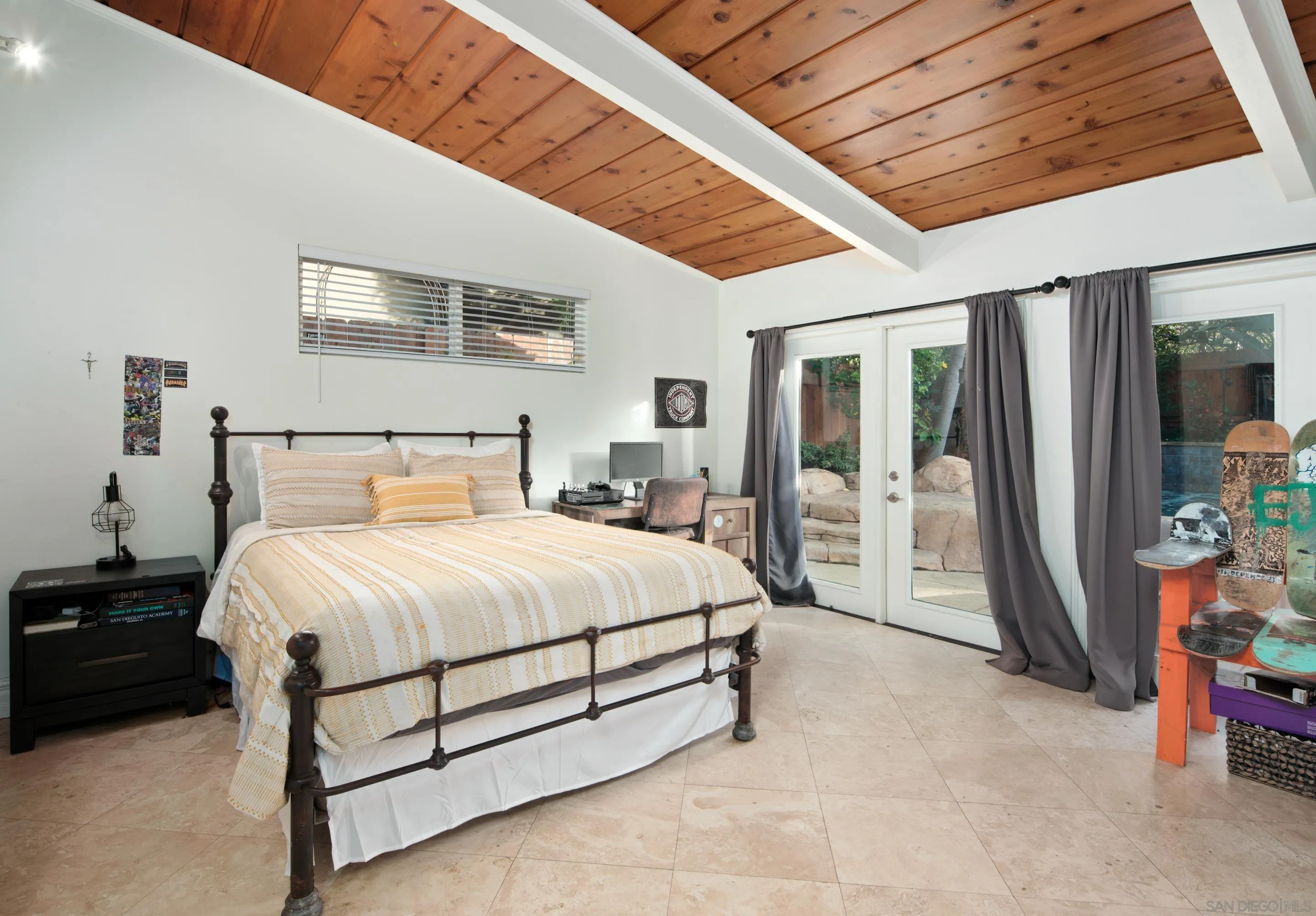 761 Ocean Crest Road Cardiff, CA 92007 - Photo 11 of 37 a spacious bedroom with a bed and a chandelier