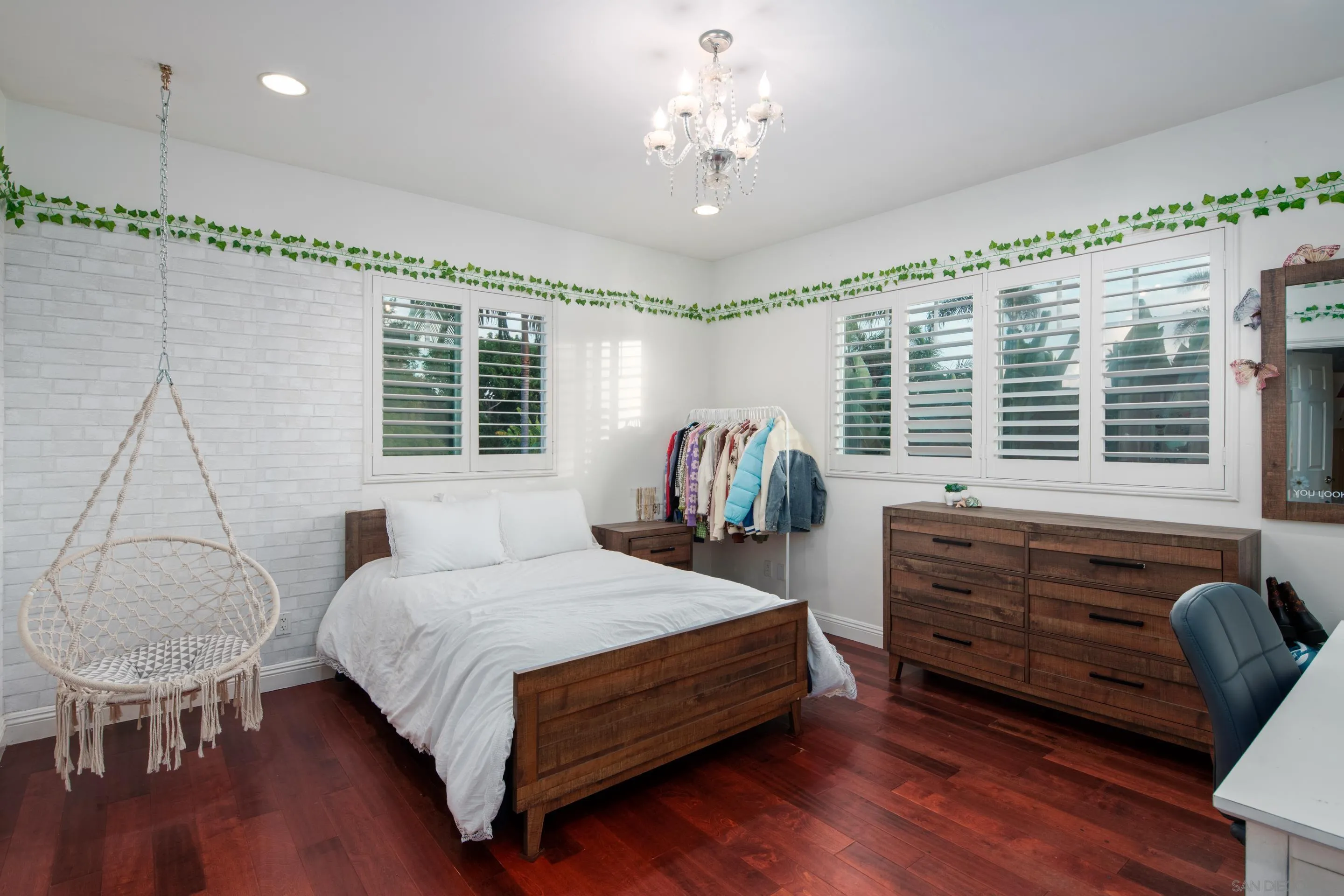 761 Ocean Crest Road Cardiff, CA 92007 - Photo 17 of 37 a bedroom with a large bed and a chandelier