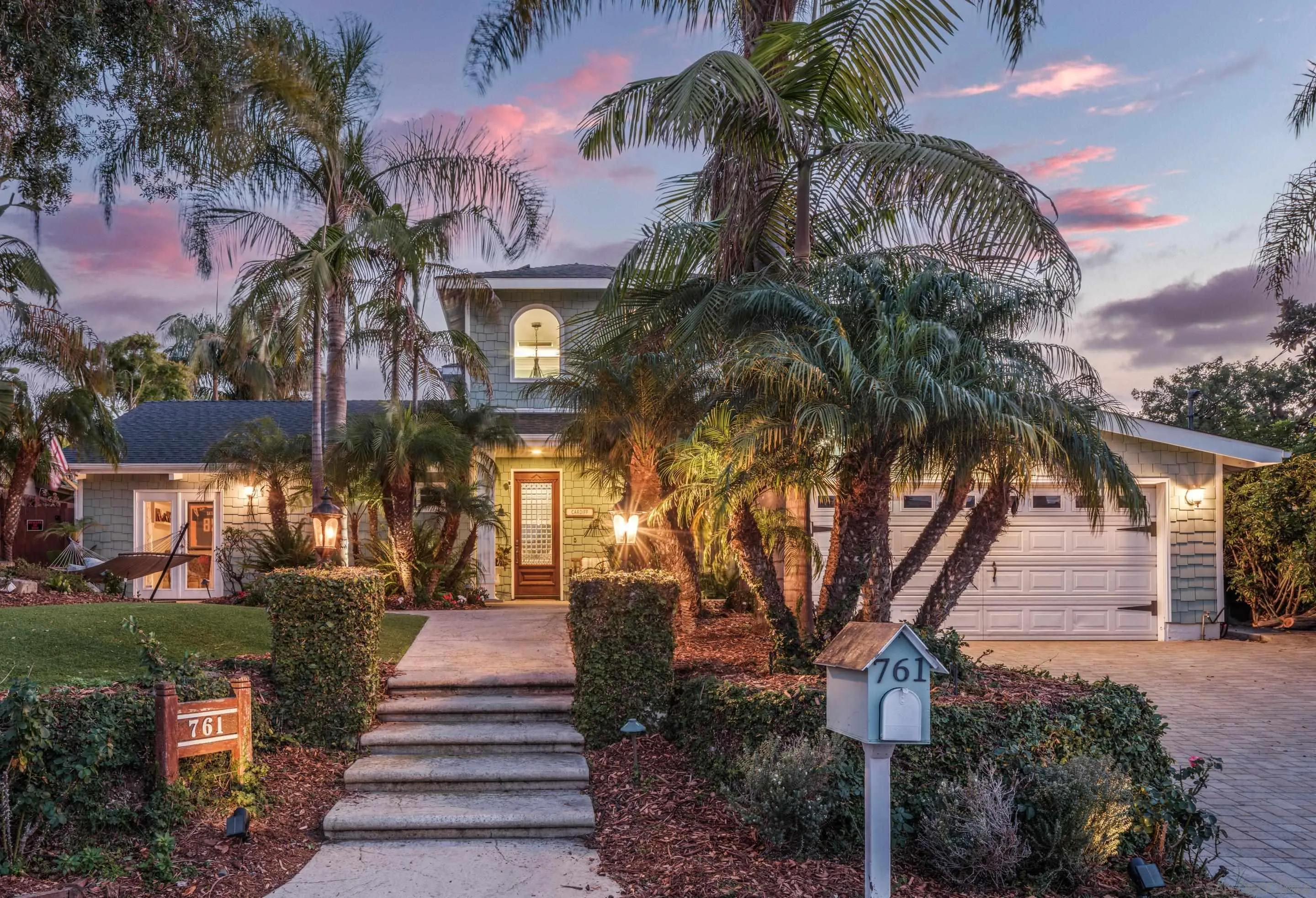 761 Ocean Crest Road Cardiff, CA 92007 - Photo 27 of 37 a front view of a house with a garden and trees