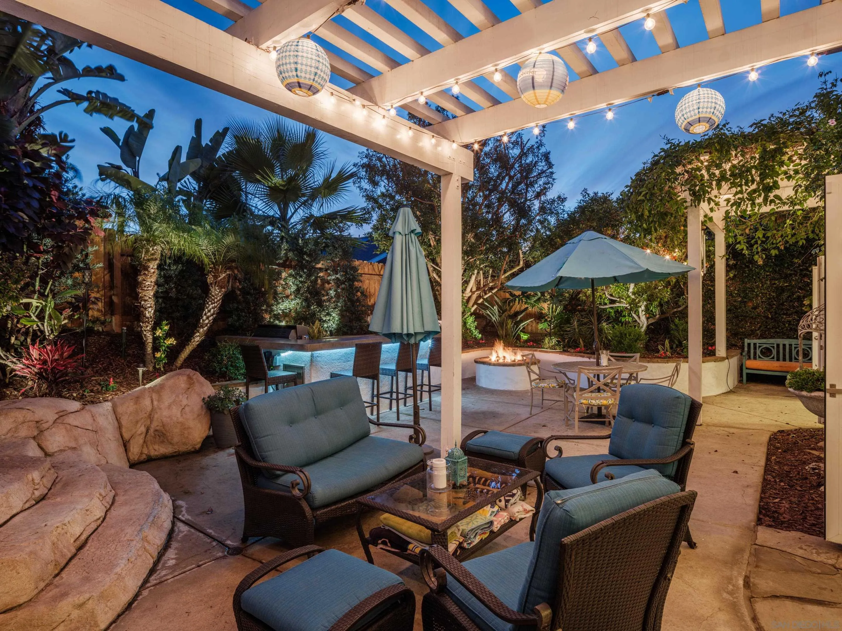 761 Ocean Crest Road Cardiff, CA 92007 - Photo 30 of 37 a view of a patio with couches and chairs under an umbrella
