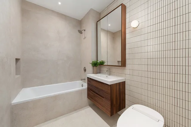 a bedroom with bed and a large window