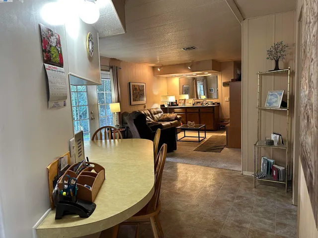 a dining room with furniture and a chandelier